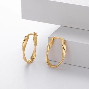 Detailed view of S925 sterling silver stamp on the gold-plated twisted Mobius earring