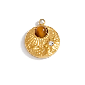 Macro shot of gold sunburst pendant with amber natural stone and clear rhinestone inlay