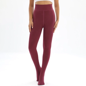 Detailed close-up of wine red high-waist thermal leggings with elastic tummy control