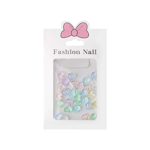 Mix of colorful aurora heart-shaped resin nail charms in a retail hanging pack