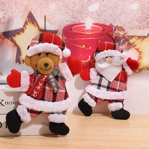 Close-up of plush Santa and bear ornaments with classic red buffalo plaid outfits