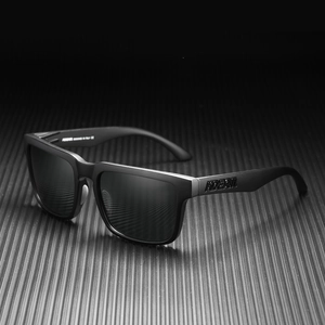 Detail view of KDEAM sports sunglasses featuring matte black frame and engraved logo