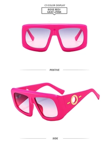 Detail view of pink rectangular sunglasses with gold ring metal accents on temples