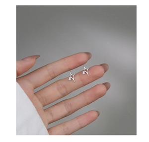 Handheld detail of s925 silver north star earrings with zircons in a minimal design