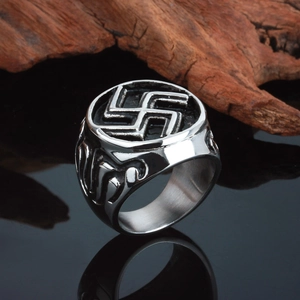 Macro view of vintage stainless steel men's ring featuring a casted swastika pattern