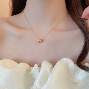 Close-up of 18k gold plated flower lock necklace with sparkling zircons on a model