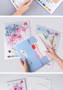 Macro detail of watercolor painting kit with floral cards and portable paint blocks