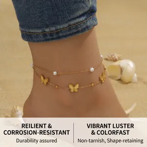 Close-up of a double-layered gold butterfly anklet with small pearls on a beach setting