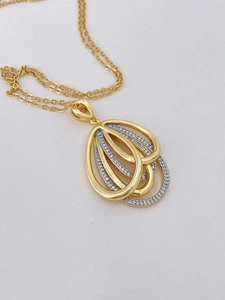 Macro shot of 18K gold plated teardrop hollow layered necklace with sparkling zircon crystals
