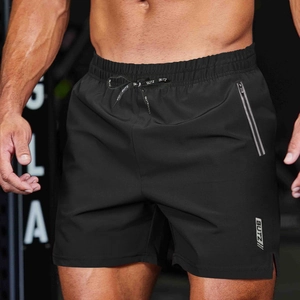 Detail of men's black sports shorts with drawstring waist and zipper pocket in the gym