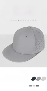 Detail view of laser-cut perforated breathable fabric on a gray snapback flat brim cap