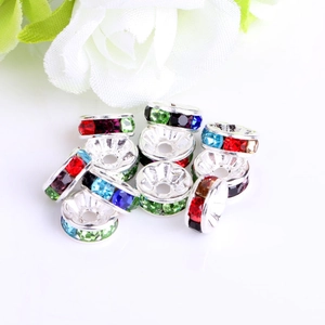 Macro detail of colorful crystal spacer beads with metal base for DIY jewelry making