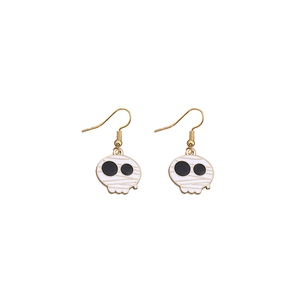 Detailed close-up of spooky white mummy skull earrings with golden accent hooks