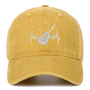 Detailed close-up of the guitar heartbeat embroidery on a mustard yellow cotton cap