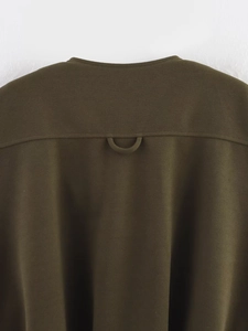 Detail view of olive green vest back with durable twill fabric and sturdy hanging loop