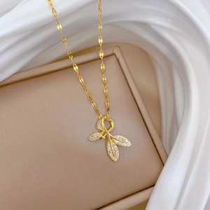 Detail of leaf pendant with micro-paved rhinestones on a gold flat water wave chain
