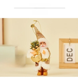 Detail of Santa figurine in champagne sequins with plush trim and golden gift box