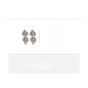 Detail of flower tassel earrings with faux pearls and rhinestones on alloy base