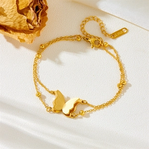 Detail of double-layer gold butterfly bracelet with small beads and S.STEEL stamp