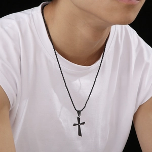 Polished black stainless steel cross necklace with twisted chain on male model
