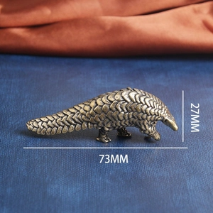 Miniature brass pangolin figurine with detailed scales, dimensions 73mm x 27mm