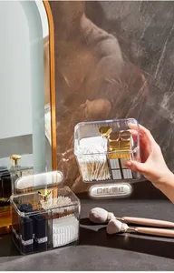 Detail of transparent acrylic organizer with gold heart handle and divided compartments