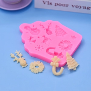Pink silicone Christmas mold for baking deer snowman snowflake shapes on blue background