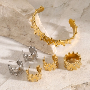 18k gold plated stainless steel jewelry set with rhinestones on stone background