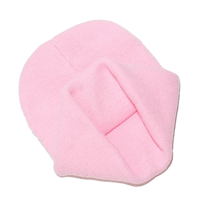 Close-up detail of soft pink ribbed knit beanie showing high-quality yarn texture