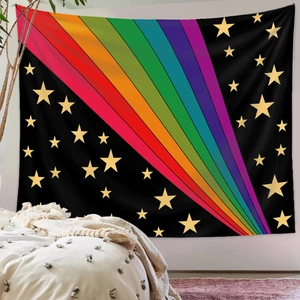 Detail of bohemian rainbow tapestry with golden stars over a bed for wall decoration