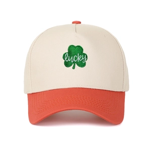 Detailed close-up of lucky clover embroidery on a two-tone color block trucker cap