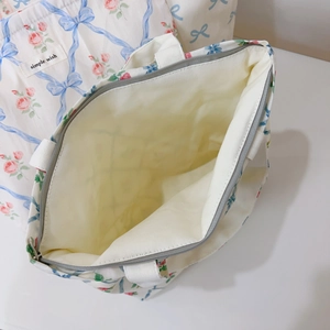 Detail view of floral canvas tote with zipper closure and spacious interior lining