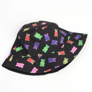 Black canvas bucket hat for women with colorful gummy bear prints on a white background
