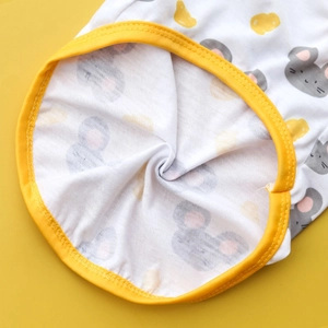 Detail of breathable white pet vest featuring cartoon mouse and cheese patterns with yellow trim
