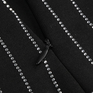 Detail of silver rhinestones and hidden zipper on a black party mini dress