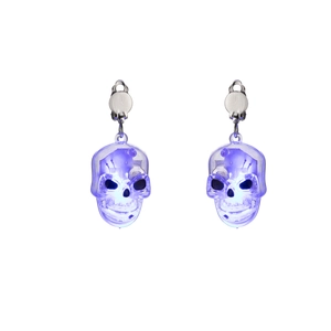 Macro detail of glowing purple LED skull earrings with silver metal spring clip
