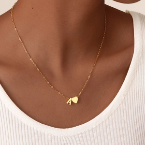 Minimalist 18K gold stainless steel necklace with heart and letter A pendant on model