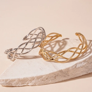 Minimalist geometric mesh twisted open bangles in polished gold and silver metal finishes