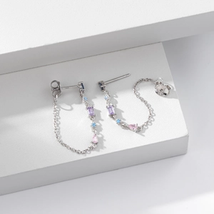 Macro detail of S925 sterling silver earrings with purple and pink zircon stones