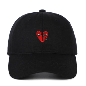 Classic black cotton baseball cap featuring red broken heart embroidery on the front