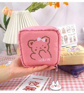 Pink cartoon bear sanitary napkin bag with zipper detail and soft fabric texture