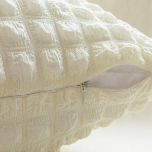 Cream white square pillow cover with 3D bubble grid texture and invisible zipper detail