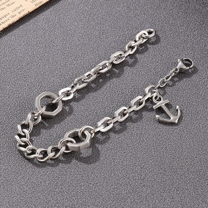 Close-up of anchor pendant and hex nut detail on men's stainless steel chain bracelet