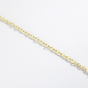 Close-up of the delicate golden metal chain links for this elegant heart pendant necklace