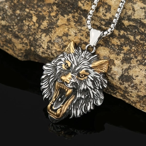 Nordic Viking wolf head pendant necklace in silver and gold steel on rock background