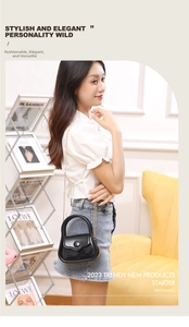 Detailed view of black patent leather mini handbag with gold chain strap and button