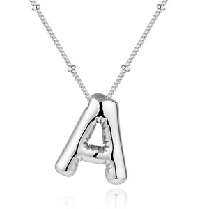 Macro shot of 3D balloon-style silver letter A pendant on a stainless steel chain