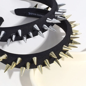 Detail of black fabric headbands featuring punk style silver and gold metallic rivet studs