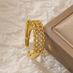 Detailed view of a gold zircon geometric ring resting on a brown jewelry gift box