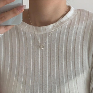 Detail of 925 sterling silver hollow donut pendant necklace worn by a model